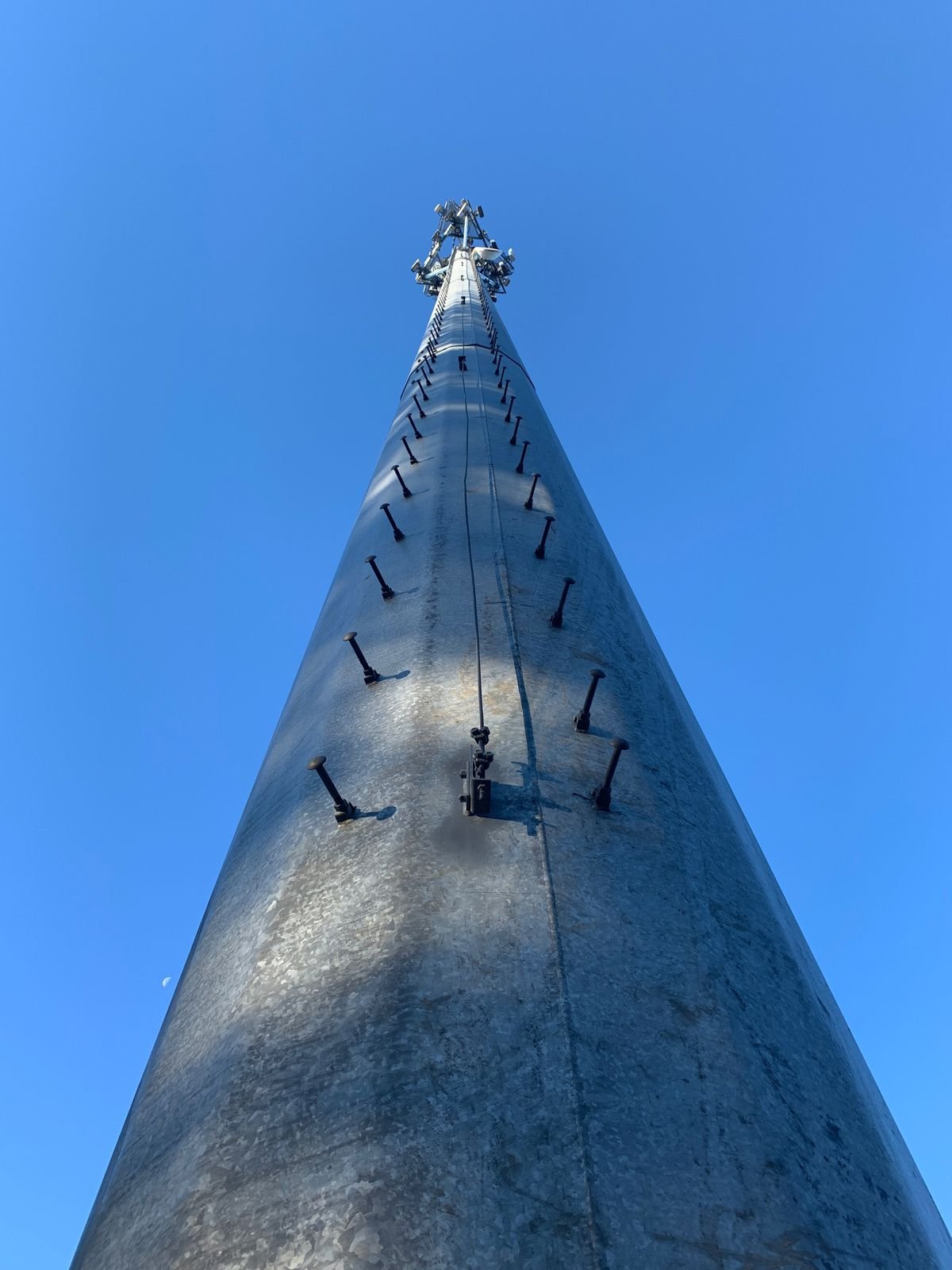 Structural engineer inspecting a bolted tower connection on site